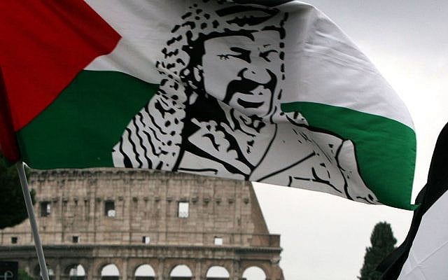 A demonstrator waves a Palestinian flag portraying Yasser Arafat during a demonstration in front of Rome's Colosseum Saturday, Oct. 30, 2004. (AP/Alessandra Tarantino) A demonstrator waves a Palestinian flag portraying Yasser Arafat during a demonstration in front of Rome's Colosseum Saturday, Oct. 30, 2004. (AP/Alessandra Tarantino)