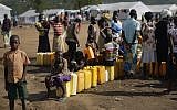 Illustrative: South Sudanese refugees line up to fill their plastic containers with water from a tap at the Imvepi reception center, where newly arrived refugees are processed before being allocated plots of land in nearby Bidi Bidi refugee settlement, in northern Uganda,, June 9, 2017. (AP Photo/Ben Curtis)