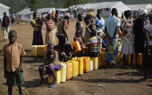 Illustrative: South Sudanese refugees line up to fill their plastic containers with water from a tap at the Imvepi reception center, where newly arrived refugees are processed before being allocated plots of land in nearby Bidi Bidi refugee settlement, in northern Uganda,, June 9, 2017. (AP Photo/Ben Curtis) Illustrative: South Sudanese refugees line up to fill their plastic containers with water from a tap at the Imvepi reception center, where newly arrived refugees are processed before being allocated plots of land in nearby Bidi Bidi refugee settlement, in northern Uganda,, June 9, 2017. (AP Photo/Ben Curtis)