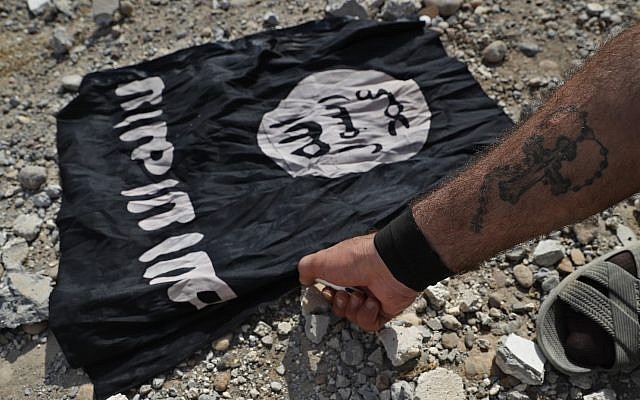 A fighter of a Christian Syriac militia that battles the Islamic State group under the banner of the US-backed Syrian Democratic Forces, burns an IS flag on the front line on the western side of Raqqa, northeast Syria, Monday, July 17, 2017. (AP Photo/Hussein Malla) A fighter of a Christian Syriac militia that battles the Islamic State group under the banner of the US-backed Syrian Democratic Forces, burns an IS flag on the front line on the western side of Raqqa, northeast Syria, Monday, July 17, 2017. (AP Photo/Hussein Malla)