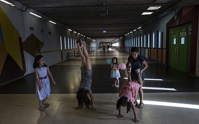 In this July 19, 2017, photo, Syrian refugee girls play in a corridor at the former prison of Bijlmerbajes in Amsterdam, Netherlands. (AP Photo/Muhammed Muheisen) In this July 19, 2017, photo, Syrian refugee girls play in a corridor at the former prison of Bijlmerbajes in Amsterdam, Netherlands. (AP Photo/Muhammed Muheisen)