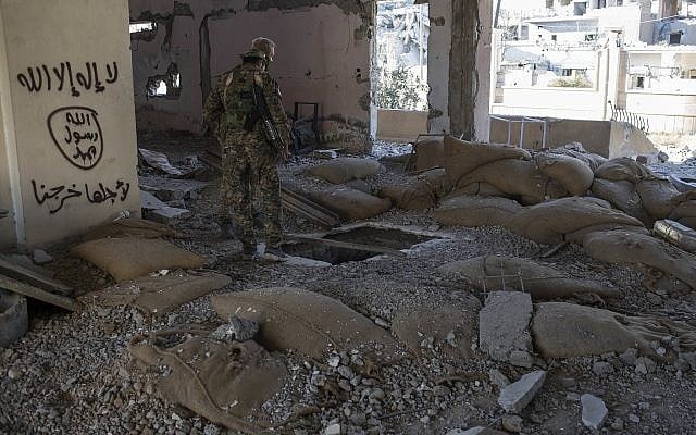 Members of the US-backed Syrian Democratic Forces (SDF) check for bombs at the stadium that was the site of Islamic State fighters' last stand in the city of Raqqa, Syria, Wednesday, October 18, 2017. (AP/Asmaa Waguih) Members of the US-backed Syrian Democratic Forces (SDF) check for bombs at the stadium that was the site of Islamic State fighters' last stand in the city of Raqqa, Syria, Wednesday, October 18, 2017. (AP/Asmaa Waguih)