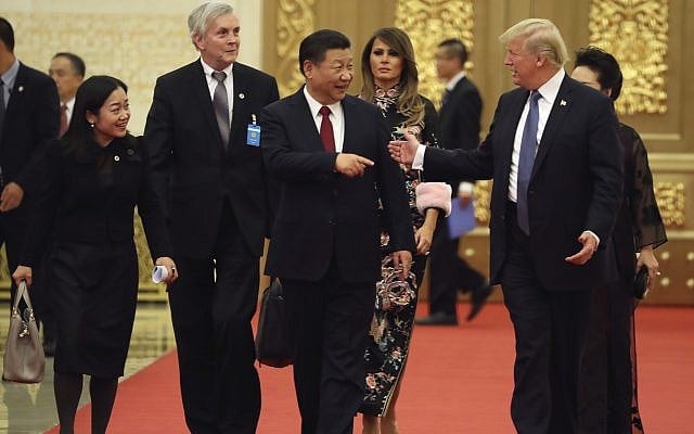 US President Donald Trump and Chinese President Xi Jinping, center, talk to each other as they arrive for a state dinner at the Great Hall of the People, Thursday, November 9, 2017, in Beijing. (AP/Andrew Harnik) US President Donald Trump and Chinese President Xi Jinping, center, talk to each other as they arrive for a state dinner at the Great Hall of the People, Thursday, November 9, 2017, in Beijing. (AP/Andrew Harnik)