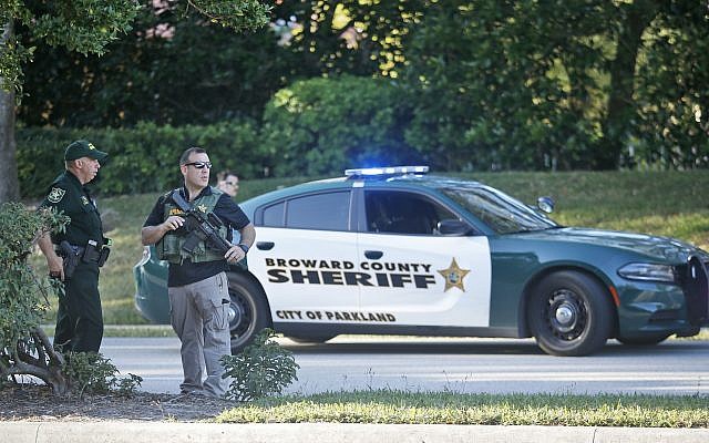 Law enforcement officers block off a street following a shooting at Marjory Stoneman Douglas High School, Wednesday, February 14, 2018, in Parkland, Florida (AP/Wilfredo Lee) Law enforcement officers block off a street following a shooting at Marjory Stoneman Douglas High School, Wednesday, February 14, 2018, in Parkland, Florida (AP/Wilfredo Lee)