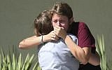 Students grieve outside Pines Trail Center where counselors are present, after Wednesday's mass shooting at Marjory Stoneman Douglas High School in Parkland, Fla., Thursday, February 15, 2018. (AP/Joel Auerbach)