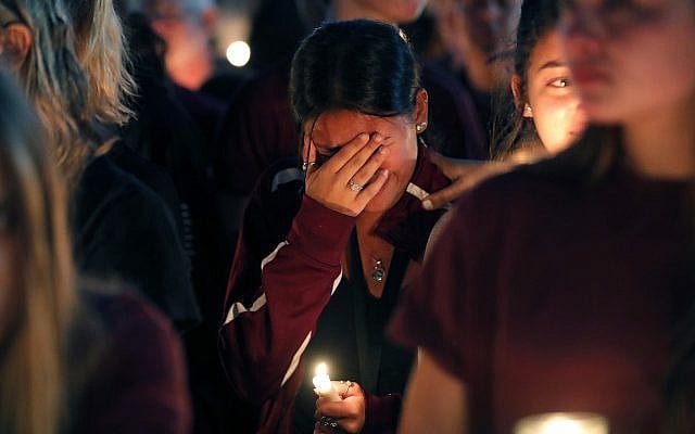 Students gather during a vigil at Pine Trails Park for the victims of the Wednesday shooting at Marjory Stoneman Douglas High School, in Parkland, Fla., Thursday, February 15, 2018. (AP Photo/Brynn Anderson)