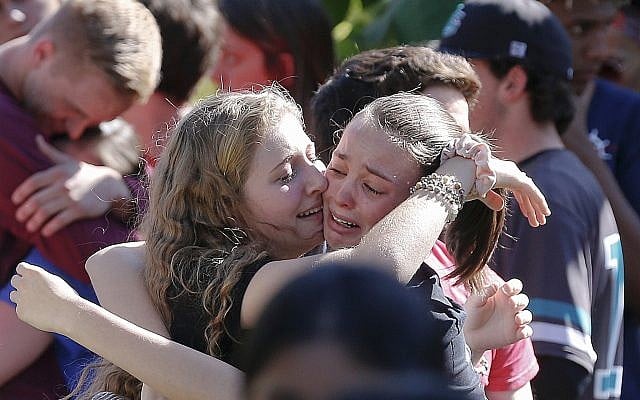 Students gather during a vigil at Pine Trails Park for the victims of the Wednesday shooting at Marjory Stoneman Douglas High School, in Parkland, Fla., Thursday, February 15, 2018. (AP Photo/Brynn Anderson)