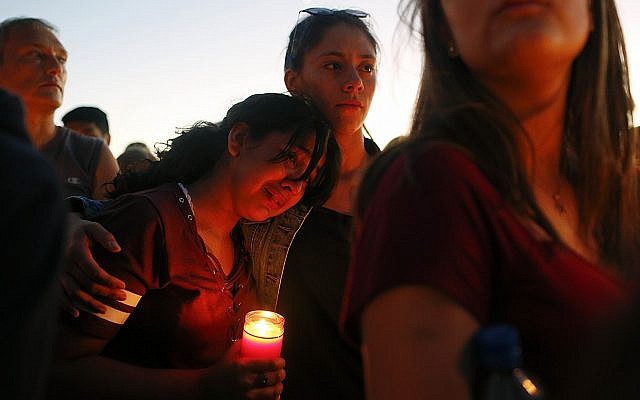 Students gather during a vigil at Pine Trails Park for the victims of the Wednesday shooting at Marjory Stoneman Douglas High School, in Parkland, Fla., Thursday, February 15, 2018. (AP Photo/Brynn Anderson)