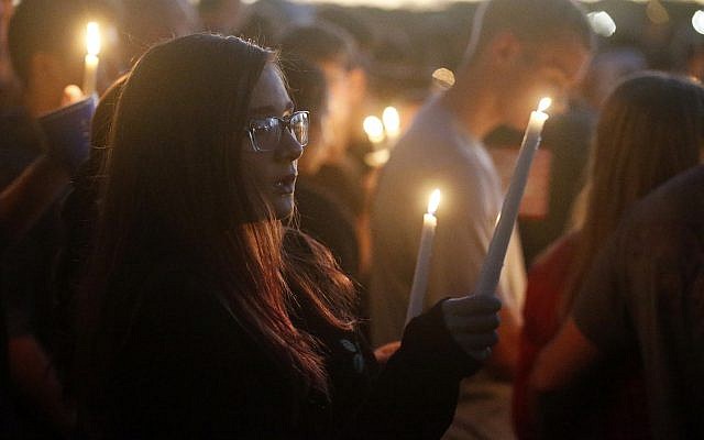 Students gather during a vigil at Pine Trails Park for the victims of the Wednesday shooting at Marjory Stoneman Douglas High School, in Parkland, Fla., Thursday, February 15, 2018. (AP Photo/Brynn Anderson)