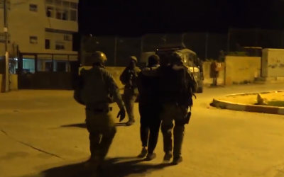 Police arrest a suspect during a raid in the West Bank town of al-Ram on February 5, 2018. (Screen capture: Twitter)