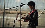 An Eritrean musician performs outside the Holot detention facility, January 29, 2018. (Luke Tress/Times of Israel)