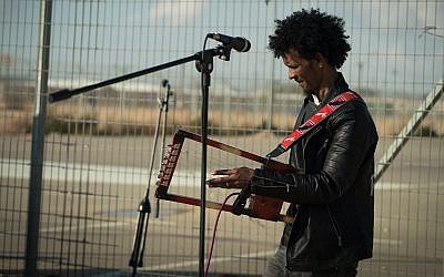 An Eritrean musician performs outside the Holot detention facility, January 29, 2018. (Luke Tress/Times of Israel)