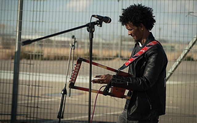 An Eritrean musician performs outside the Holot detention facility, January 29, 2018. (Luke Tress/Times of Israel)