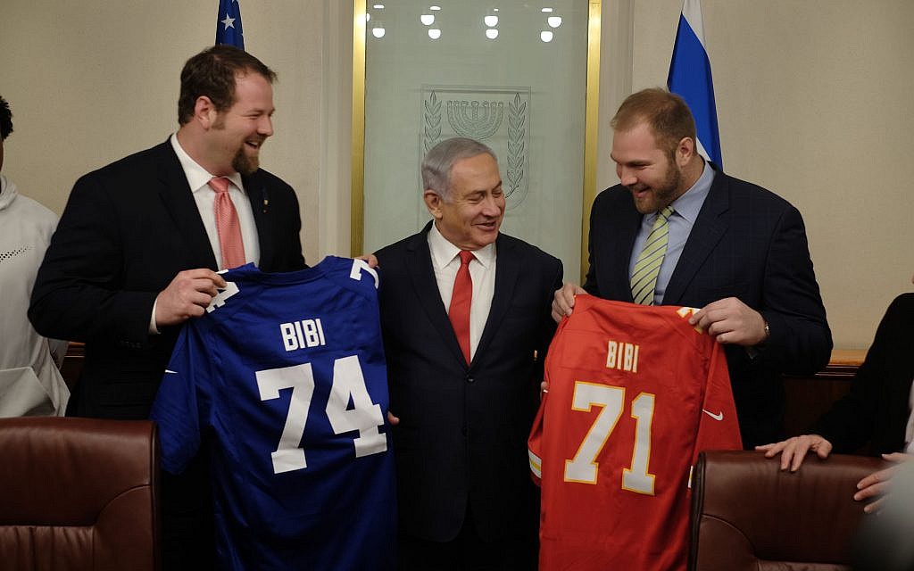 Jewish NFL football players and brothers Geoff (l) and Mitchell (r) Schwartz present Prime Minister Benjamin Netanyahu with football jerseys that have his nickname on them, in his Jerusalem office, on February 19, 2018. (Judah Ari Gross/Times of Israel) Jewish NFL football players and brothers Geoff (l) and Mitchell (r) Schwartz present Prime Minister Benjamin Netanyahu with football jerseys that have his nickname on them, in his Jerusalem office, on February 19, 2018. (Judah Ari Gross/Times of Israel)