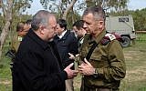 Defense Minister Avigdor Liberman, left, speaks to IDF Deputy Chief of Staff Maj. Gen. Aviv Kochavi in a field just outside the Gaza Strip on February 20, 2018. (Judah Ari Gross/Times of Israel)