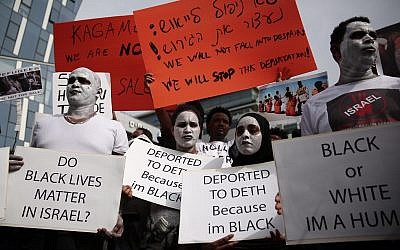 African asylum seekers and rights activists protest against deportation in front of the Rwandan Embassy in Herzliya, on February 7, 2018. (Miriam Alster/Flash90)