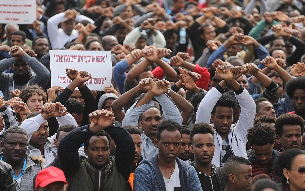African asylum seekers and human rights activists protest against the deportation plan, in front of the Rwandan embassy in Herzliya, on February 7, 2018. (Miriam Alster/Flash90)