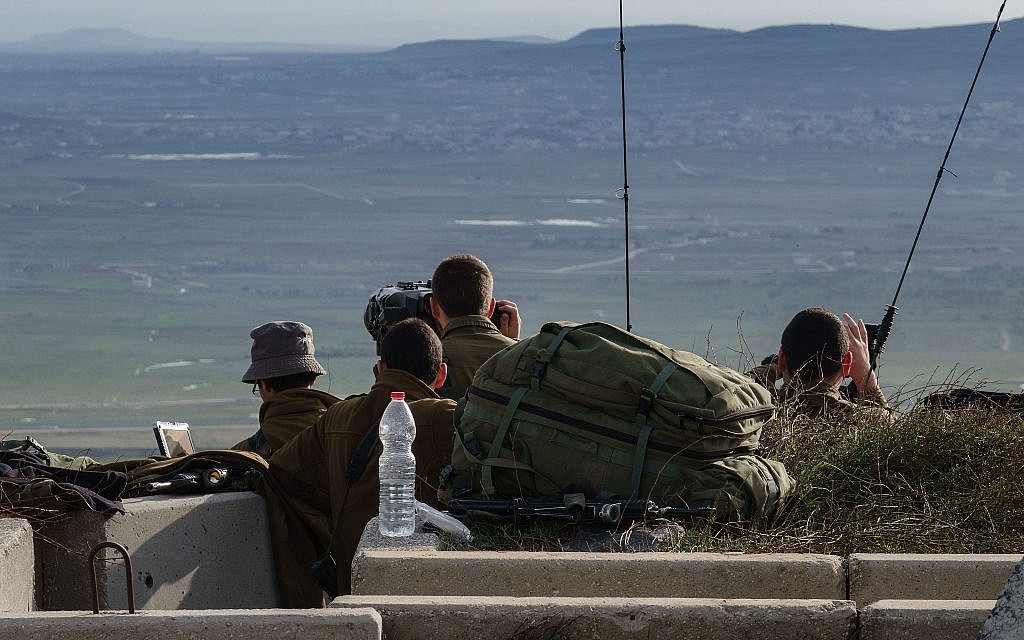 Israeli soldiers survey the border with Syria from a military post in the Golan Heights, following a series of aerial clashes with Syrian and Iranian forces in Syria, on February 10, 2018. (Flash90)