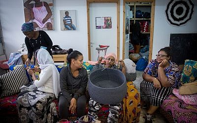 Women of the Kuchinate Collective crochet baskets in their workshop in south Tel Aviv on December 20, 2017. (Miriam Alster/Flash90)