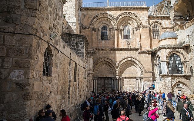 People gather outside the closed doors of the Church of the Holy Sepulchre in Jerusalem's Old City on February 25, 2018. (Hadas Parush/Flash90) People gather outside the closed doors of the Church of the Holy Sepulchre in Jerusalem's Old City on February 25, 2018. (Hadas Parush/Flash90)