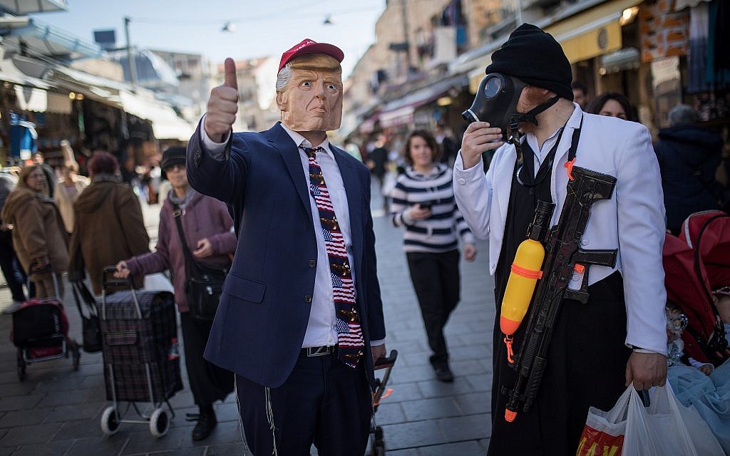 People dressed up in costumes for the Jewish holiday of Purim shop at Jerusalem's Mahane Yehuda market on February 28, 2018. (Hadas Parush/Flash90) People dressed up in costumes for the Jewish holiday of Purim shop at Jerusalem's Mahane Yehuda market on February 28, 2018. (Hadas Parush/Flash90)