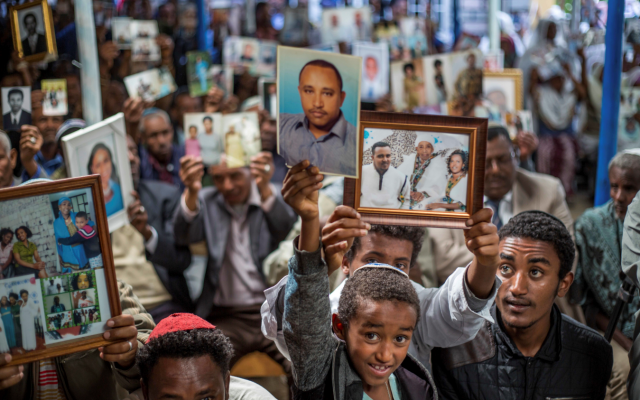 Members of Ethiopia's Jewish community hold pictures of their relatives in Israel, during a solidarity event at the synagogue in Addis Ababa, Ethiopia, February 28, 2018. (AP Photo/Mulugeta Ayene) Members of Ethiopia's Jewish community hold pictures of their relatives in Israel, during a solidarity event at the synagogue in Addis Ababa, Ethiopia, February 28, 2018. (AP Photo/Mulugeta Ayene)