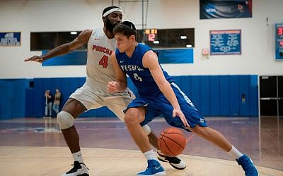 Gabriel Leiter of Yeshiva University drives on a Purchase College defender in the Skyline Conference championship game, February 25, 2018. (Courtesy of Yeshiva University via JTA)