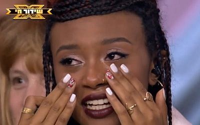 X-Factor contestant Eden Alene sobs after being declared the winner of the 2018 Israeli show (Facebook/Reshet)