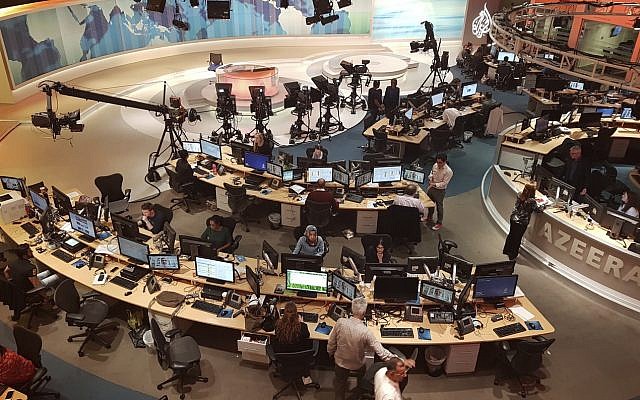 Al Jazeera staff work at their TV station in Doha, Qatar, on June 8, 2017. (AP Photo/Malak Harb)