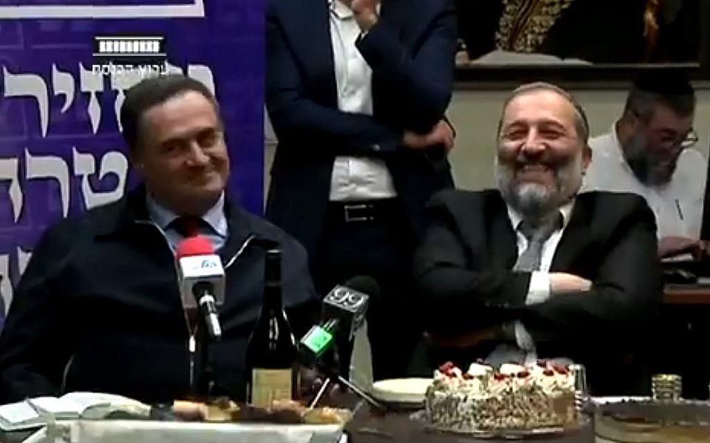 Transportation Minister Israel Katz (left) and Interior Minister Aryeh Deri at a birthday celebration for Deri in the Knesset, February 26, 2018 (screenshot: Knesset Channel)