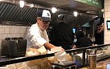 Israeli chef Eyal Shani prepares a pita in the newly-opened New York branch of his Miznon restaurant chain. (Danielle Ziri/Times of Israel)