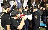 Activists with the Central Bus Station Citizen's Watch Group argue with police at a demonstration in south Tel Aviv on December 17, 2017. (courtesy, Central Bus Station Citizen's Watch Group/Facebook)