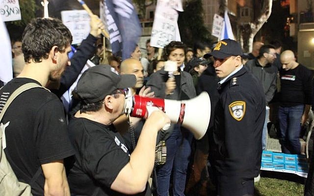 Activists with the Central Bus Station Citizen's Watch Group argue with police at a demonstration in south Tel Aviv on December 17, 2017. (courtesy, Central Bus Station Citizen's Watch Group/Facebook) Activists with the Central Bus Station Citizen's Watch Group argue with police at a demonstration in south Tel Aviv on December 17, 2017. (courtesy, Central Bus Station Citizen's Watch Group/Facebook)
