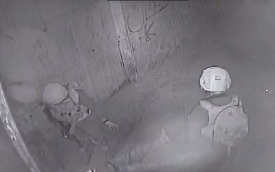 CCTV footage shows soldiers crouching over a wounded Palestinian in an alley in the West Bank city of Jericho, February 22, 2018.
