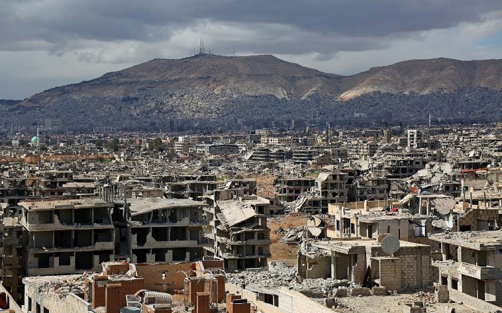 A picture taken on February 27, 2018, shows a view of the rebel-held neighborhood of Jobar, on the eastern edge of the Syrian capital Damascus, following a reported regime bombardment, with Mount Qasioun seen in the background. (AFP Photo/Ammar Suleiman)