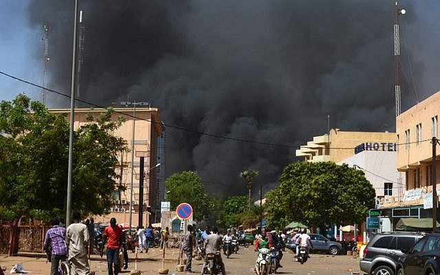 People watch as black smoke rises as the capital of Burkina Faso came under multiple attacks on March 2, 2018, targeting the French embassy, the French cultural center and the country's military headquarters. (AFP/Ahmed Ouoba) People watch as black smoke rises as the capital of Burkina Faso came under multiple attacks on March 2, 2018, targeting the French embassy, the French cultural center and the country's military headquarters. (AFP/Ahmed Ouoba)