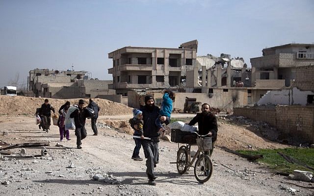 Syrians flee their homes with their belongings in the town of Beit Sawa in Syria's besieged Eastern Ghouta region on March 4, 2018, following reported regime air strikes. (AFP Photo/Abdulmonam Eassa) Syrians flee their homes with their belongings in the town of Beit Sawa in Syria's besieged Eastern Ghouta region on March 4, 2018, following reported regime air strikes. (AFP Photo/Abdulmonam Eassa)