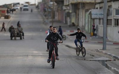 Palestinian boys ride bicycles in Gaza City on March 8, 2018. (AFP/ MOHAMMED ABED)