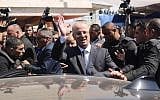 Palestinian Authority Prime Minister Rami Hamdallah waves to the crowd upon his arrival in Gaza City on March 13, 2018. (AFP PHOTO / MAHMUD HAMS)