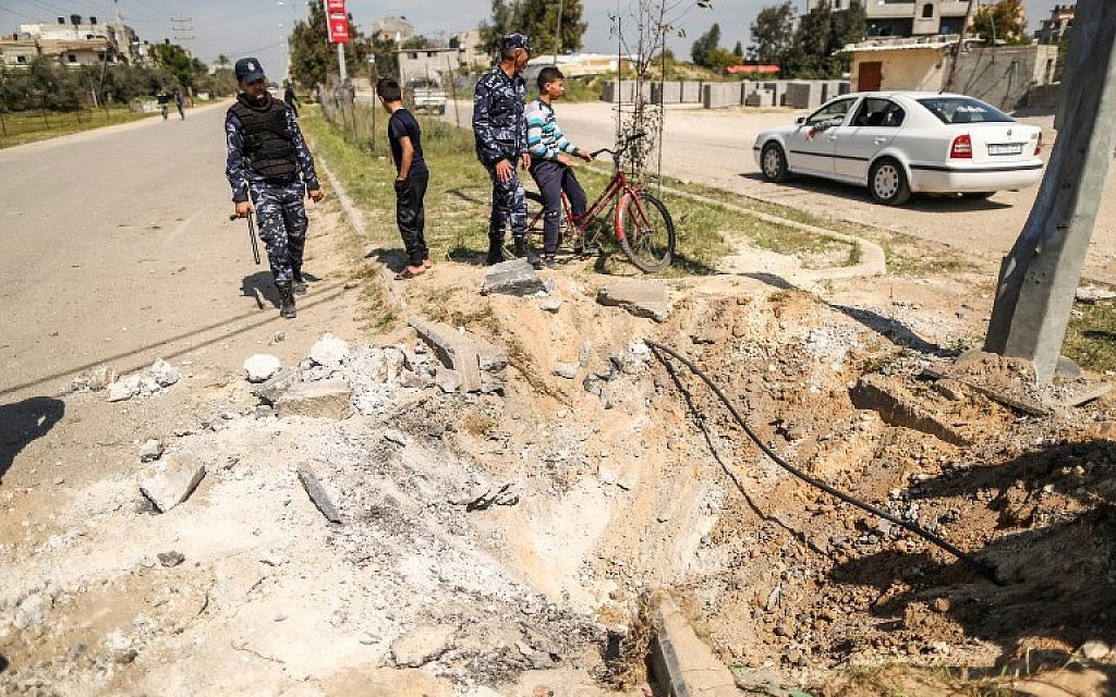 Members of the Hamas security forces inspect the crater left at the site of an explosion that targeted the convoy of the Palestinian Prime Minister during his visit to the Gaza strip on March 13, 2018. (AFP/ MAHMUD HAMS) Members of the Hamas security forces inspect the crater left at the site of an explosion that targeted the convoy of the Palestinian Prime Minister during his visit to the Gaza strip on March 13, 2018. (AFP/ MAHMUD HAMS)