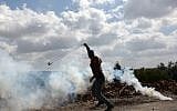 A young Palestinian protester prepares to fire a slingshot during clashes with Israeli soldiers in the village of Kfar Qaddum, near Nablus, in the West Bank, on March 16, 2018. (AFP PHOTO / JAAFAR ASHTIYEH)