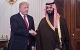 US President Donald Trump and Saudi Deputy Crown Prince, left, and Saudi Defense Minister Mohammed bin Salman, who later that year became Crown Prince of Saudi Arabia, shaking hands in the State Dining Room before lunch at the White House in Washington, DC,  March 14, 2017. (NICHOLAS KAMM/AFP)