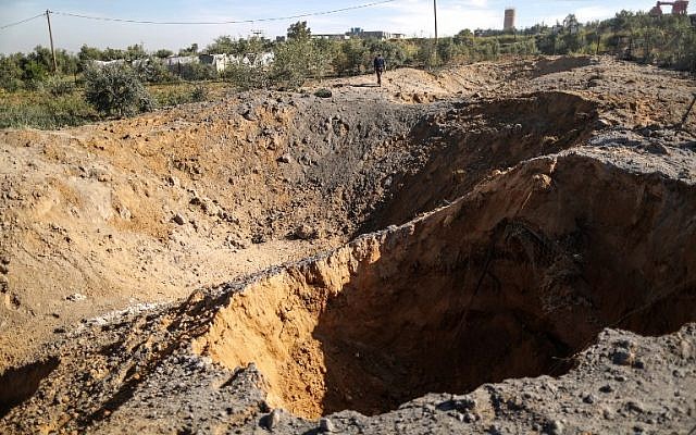 A Palestinian man checks the site of an Israeli airstrike in Gaza City on March 18, 2018. (AFP/Mahmud Hams) A Palestinian man checks the site of an Israeli airstrike in Gaza City on March 18, 2018. (AFP/Mahmud Hams)