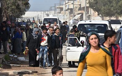 Syrian civilians fleeing the city of Afrin in northern Syria are seen as they enter the town of Tal Rifaat in the government-controlled part of the northern Aleppo province, on March 18, 2018. (AFP PHOTO / George OURFALIAN)