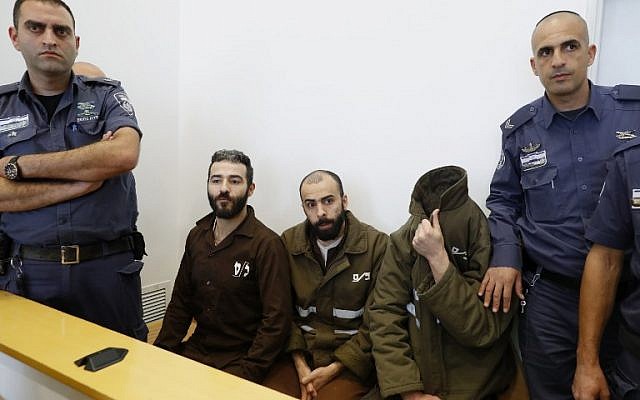 French national Romain Franck (R), 24, a worker at the French consulate, and Palestinian Moufak al-Ajluni (L) and Mohamed Katout (C) appear in court the southern Israeli city of Beersheba on March 19, 2018, to face charges of smuggling guns from Gaza. (AFP PHOTO / JACK GUEZ) French national Romain Franck (R), 24, a worker at the French consulate, and Palestinian Moufak al-Ajluni (L) and Mohamed Katout (C) appear in court the southern Israeli city of Beersheba on March 19, 2018, to face charges of smuggling guns from Gaza. (AFP PHOTO / JACK GUEZ)