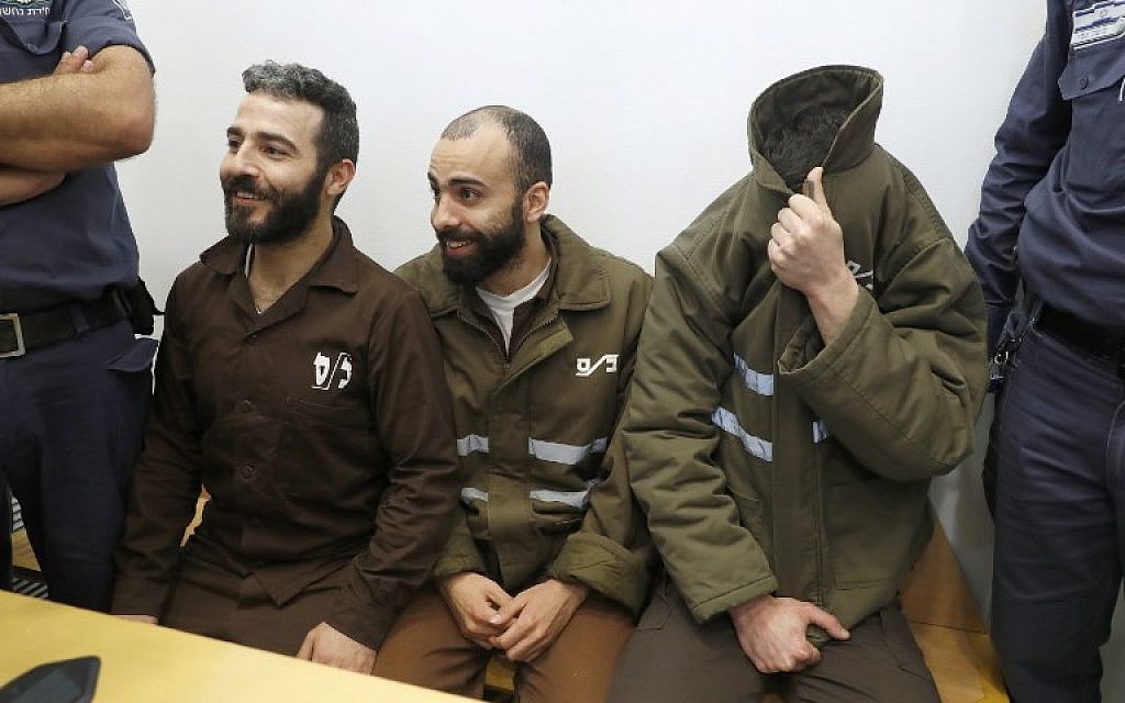 French national Romain Franck (R), then 24, a worker at the French consulate, and Palestinians Moufak al-Ajluni (L) and Mohamed Katout (C) appear in court in the Israeli city of Haifa on March 19, 2018, to face charges of smuggling guns from Gaza. (AFP Photo/Jack Guez)