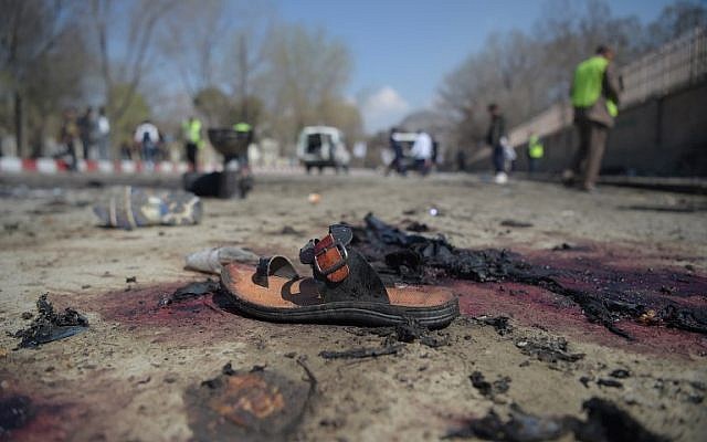 A sandal is seen laying on the ground along a road at the site of a suicide bombing attack in Kabul on March 21, 2018. (AFP PHOTO / SHAH MARAI) A sandal is seen laying on the ground along a road at the site of a suicide bombing attack in Kabul on March 21, 2018. (AFP PHOTO / SHAH MARAI)