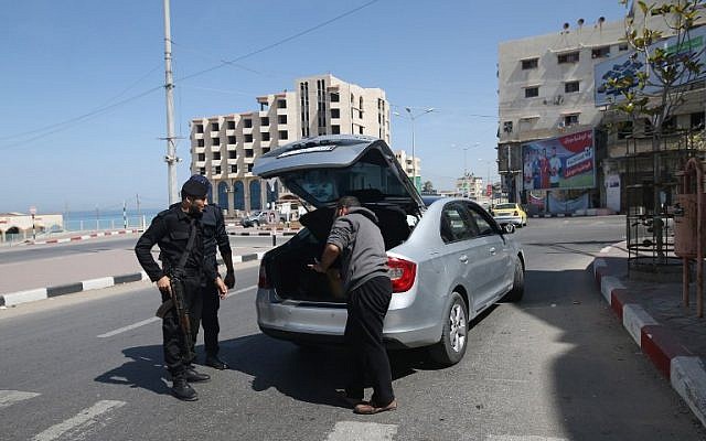 Illustrative: Hamas police inspect the trunk of a car at a checkpoint amid tightened security around Gaza city on March 22, 2018. (AFP/Mohammed Abed) Illustrative: Hamas police inspect the trunk of a car at a checkpoint amid tightened security around Gaza city on March 22, 2018. (AFP/Mohammed Abed)