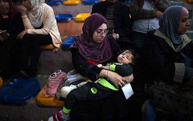 Palestinians wait for travel permits to cross into Egypt through the Rafah border crossing after it was opened by Egyptian authorities for humanitarian cases, in Khan Yunis in the southern Gaza Strip on March 23, 2018. (AFP PHOTO / MOHAMMED ABED)