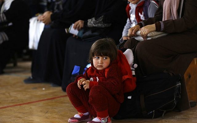Palestinians wait for travel permits to cross into Egypt through the Rafah border crossing after it was opened by Egyptian authorities for humanitarian cases, in Khan Yunis in the southern Gaza Strip on March 23, 2018 (AFP PHOTO / MOHAMMED ABED)